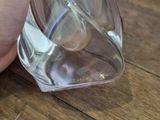 a person that is holding a bottle of water on a table
