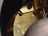 a close up view of a clock with a metal case