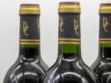 three bottles of wine that are sitting on a table