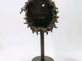a sculpture of a face in the middle of a piece of wood