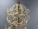 a chandelier made of glass beads hanging from the ceiling