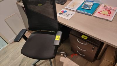 a desk with a chair and a computer on it