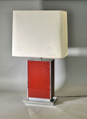 an image of a red and white lamp on a table