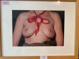 a picture of a woman with a red ribbon on her chest