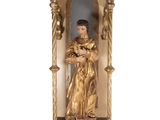 statue of a man in a golden robe in a niche