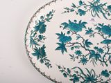a blue and white plate with flowers and birds on it