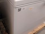 a white refrigerator that is sitting on a pallet