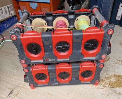 a box with a bunch of spools in it on the floor