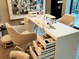 a white desk with a chair and a computer on it