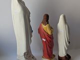 three figurines of jesus, mary, and a woman in white robes