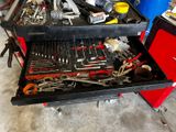 a tool cart with many tools on it in a garage
