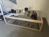 a glass coffee table with a cat statue on top of it