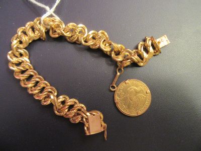 an image of a gold chain bracelet with a coin on it