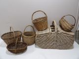 several wicker baskets are lined up on a white table