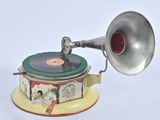 a silver and red gramphone on a yellow stand