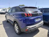 a blue car parked in a parking lot with other cars