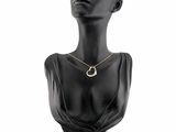 a black mannequin head with a gold necklace on it