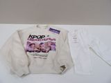 the sweater is white and has a picture of a group of people on it