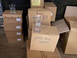 many cardboard boxes stacked on top of each other on the floor