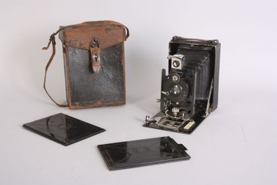 a small camera and a small case on a white surface