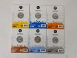 four different types of coins are on a white surface