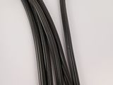 two pieces of black wire are laying on a white surface