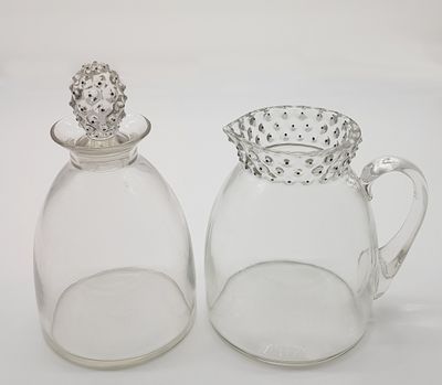 pair of clear glass salt and pepper shakers with a crown on top