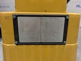 the back end of a yellow machine with a metal plate on it