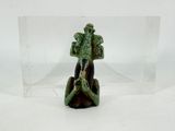 a small figurine of a man sitting on a rock