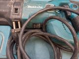 a corded drill with a cord attached to it