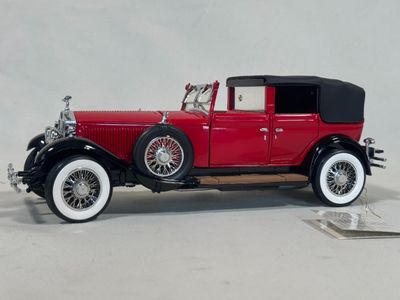 a model of a red car on display on a table