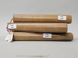 three rolls of brown paper sitting on top of each other on top of a table