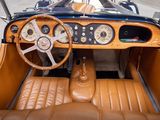a dashboard and steering wheel of a vintage car