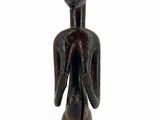 wooden statue of a man with a hat on his head