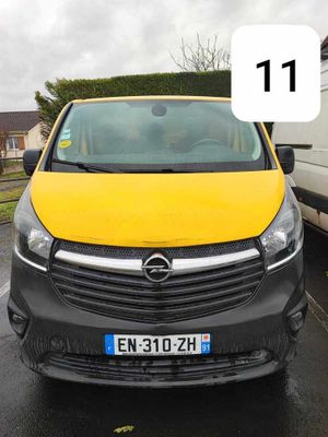 a yellow van parked in a parking lot with a number 11 on the front
