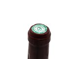 a bottle of wine that has a green label on it