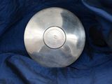 a metal object that is laying on a blue cloth