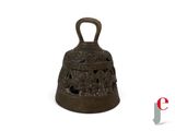 a small bell that is sitting on a white surface