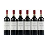 quatre bouteilles de vin rouge sont alignées
