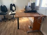a desk with two chairs and a computer on top of it