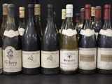 several bottles of wine are lined up in a row on a table