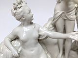 a statue of a man and a woman sitting on a rock