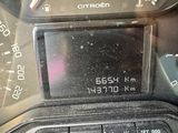 a close up of a car dashboard with a digital clock