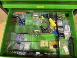 a green tool box filled with assorted items