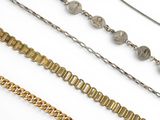 several different types of chains on a white surface