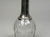 an image of a glass bottle with a silver lid
