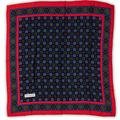 a red, blue and green square patterned scarf with a red border