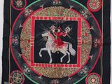 a black square scarf with a picture of a woman riding a horse
