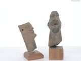 two statues of a man and a woman on wooden blocks