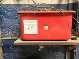 a red box sitting on top of a shelf in a room